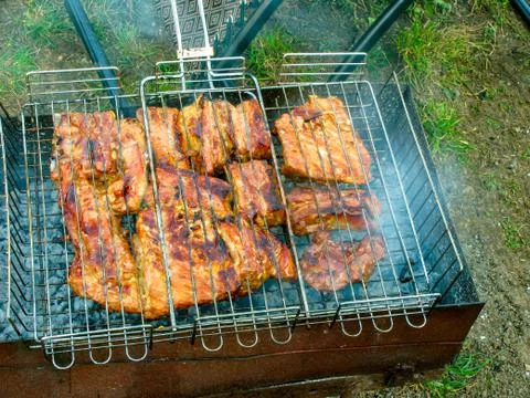 The process of cooking meat on the grill Stock Photos