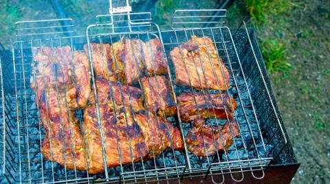 The process of cooking meat on the grill Stock Photos