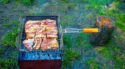 The process of cooking meat on the grill Stock Photos