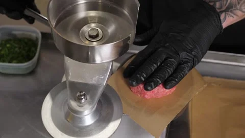 The process of cooking meat patties for a burger with a special burger press. Stock Footage 342702532