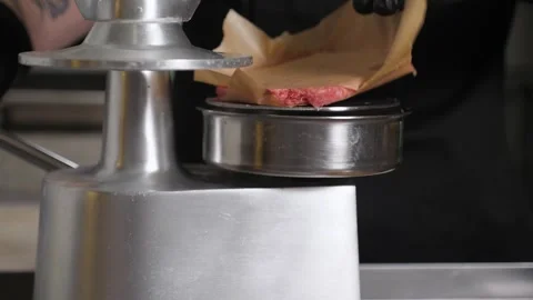 The process of cooking meat patties for a burger with a special burger press. Stock Footage 343736464