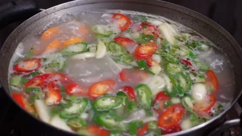The process of cooking meat soup with various spices and vegetables Stock Footage 298440374