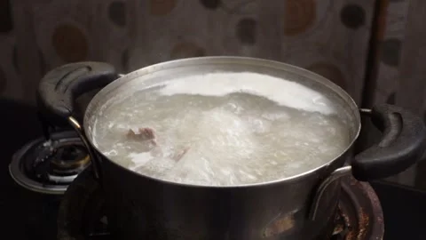 The process of cooking meat soup with various spices and vegetables Stock Footage 298440375