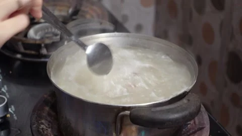 The process of cooking meat soup with various spices and vegetables Stock Footage 298444391