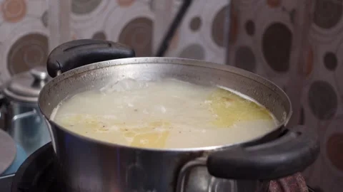 The process of cooking meat soup with various spices and vegetables Stock Footage 298444392