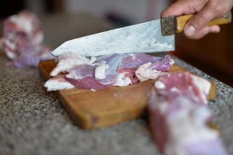 The process of cooking meat with vegetables wrapped in foil, on the grill at  Stock Photos