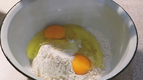 Process of cooking. Milk is poured into bowl with dough ingredients. Stock Footage 232958122