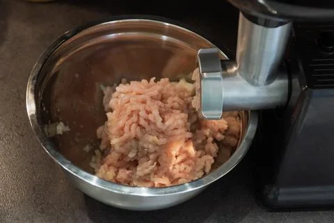 The process of cooking minced using an grinder. Stock Photos