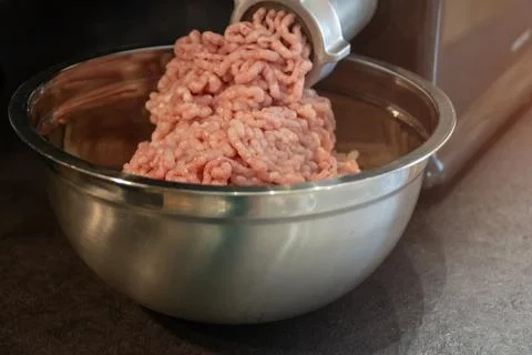 The process of cooking minced using an grinder. Stock Photos