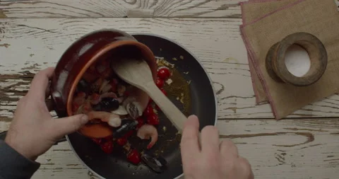 Process of cooking  mix of seafood and tomato sauce on the cooking pan Stock Footage 148320849