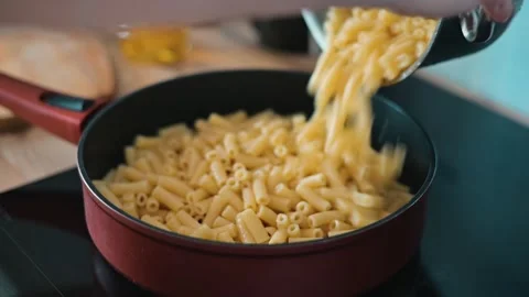The process of cooking pasta is shown through a series of clips that highlight Stock Footage 338290475