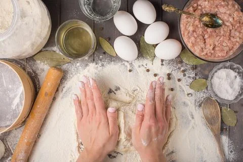 Process of cooking pelmeni with chef's hands, top view Stock Photos