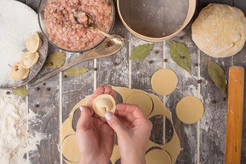 Process of cooking pelmeni with chef's hands, top view Stock Photos