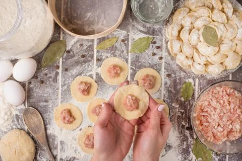 Process of cooking pelmeni with chef's hands, top view Stock Photos