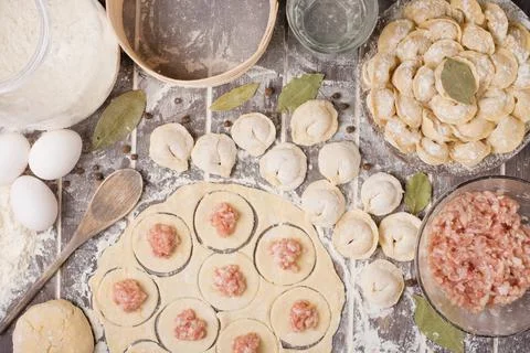 Process of cooking pelmeni with chef's hands, top view Stock Photos