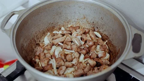 The process of cooking pilaf in a cauldron on a gas stove. Eastern cuisine Stock Footage 147747262