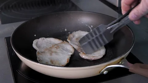 The process of cooking pork meat, chops in a frying pan. Induction cooker Stock Footage 132184347