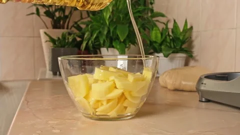 Process of cooking potatoes rustic. Slicing potatoes. Mix spices, oil. Bake on Stock Footage 244720288