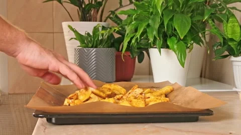 Process of cooking potatoes rustic. Slicing potatoes. Mix spices, oil. Bake on Stock Footage 244804490