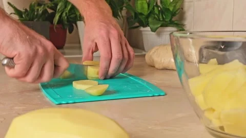 Process of cooking potatoes rustic. Slicing potatoes. Mix spices, oil. Bake on Stock Footage 246070660