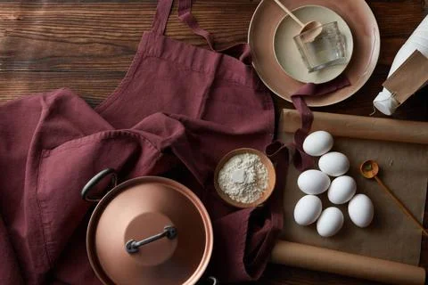 The process of cooking The process of cooking. Fresh eggs, flour, pan apro... Stock Photos
