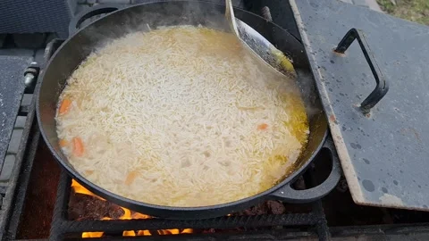 Process of cooking real oriental pilaf with meat, garlic, spices Stock Footage 152633228