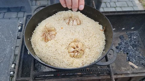 Process of cooking real oriental pilaf with meat, garlic, spices Stock Footage 152633265