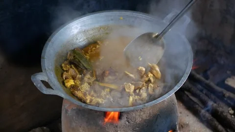 The process of cooking Rendang on a Earthenware furnace Stock Footage 281218737
