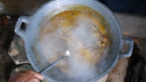 The process of cooking Rendang on a Earthenware furnace Stock Footage 281218751