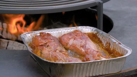 Process of cooking roasted turkey legs in disposable aluminium foil container Video stock 144005517