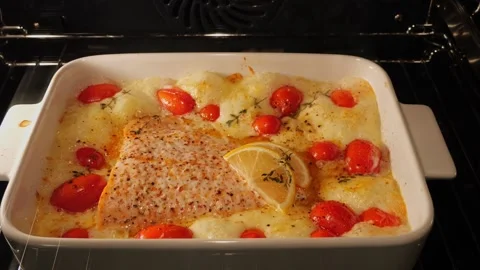 Process of cooking salmon fillet with tomato and mozzarella in oven. Time lapse Stock Footage 250040027