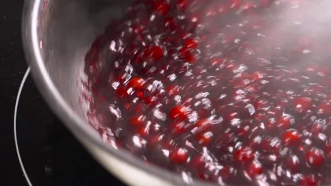 The process of cooking sauce for a cranberry dish. Video stock 248160167