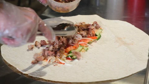 Process of cooking shawarma. Chicken shawarma cooking in restaurant kitchen. Stock Footage 153214537