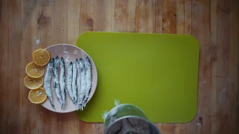 The process of cooking a small fish, preparing for frying in oil in a frying pan Stock Footage 105066451