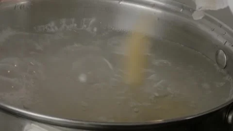 Process cooking spaghetti in boiling water. Boiling pasta in pot, close up Stock Footage 241600601