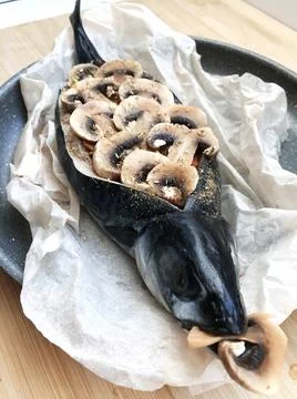 The process of cooking stuffed mackerel with vegetables, mushrooms and spices Stock-Fotos