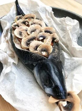 The process of cooking stuffed mackerel with vegetables, mushrooms and spices Stock Photos