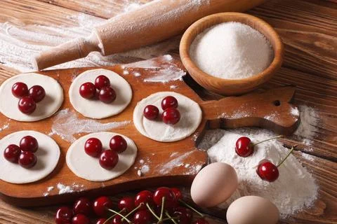 The process of cooking sweet dumplings with cherries close-up. horizontal Stock Photos