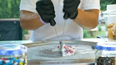 The process of cooking Thai ice cream with berries at a street food festival Stock Footage 112063735