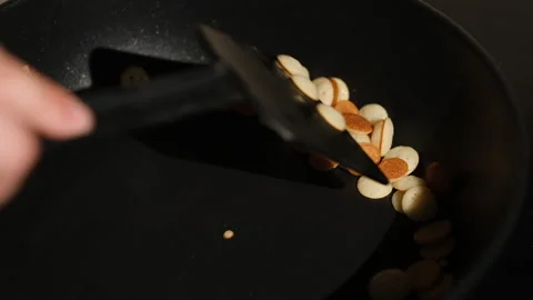 Process of cooking tiny mini pancake cereal. Dough is poured into hot pan 動画素材 150588766