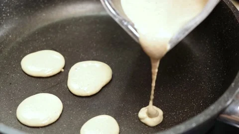 Process of cooking tiny pancake cereal - trendy quarantine food. 動画素材 131106574