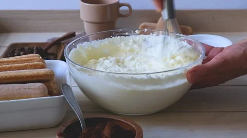 The process of cooking tiramisu. Making cream for tiramisu Stock Footage 235060836