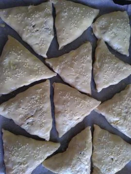The process of cooking triangular meat pies, top sprinkled Foto stock