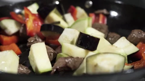 The process of cooking vegetables in a pan at home. Fried vegetables with meat 库存影片 132039170