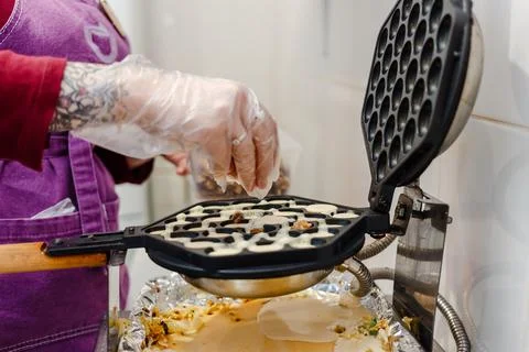 The process of cooking wafers with nuts in kitchen. Stock Photos