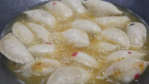 The process of cooking West Javanese cireng in a frying pan with hot oil Stock Footage 321979569
