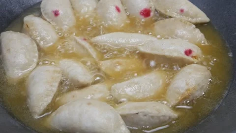 The process of cooking West Javanese cireng in a frying pan with hot oil Stock Footage 321979574
