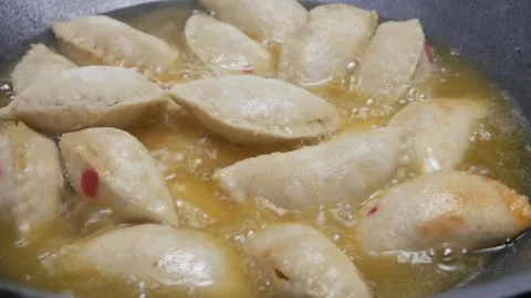 The process of cooking West Javanese cireng in a frying pan with hot oil Stock Footage 321979577