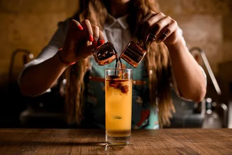 The process of creating bumble coffee. Pouring espresso into glass with orange 스톡 사진