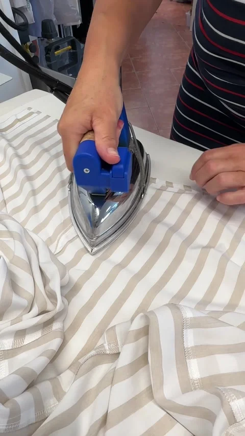 The process of creating clothes in the atelier. A man skillfully irons a collar Stock Footage 312565556